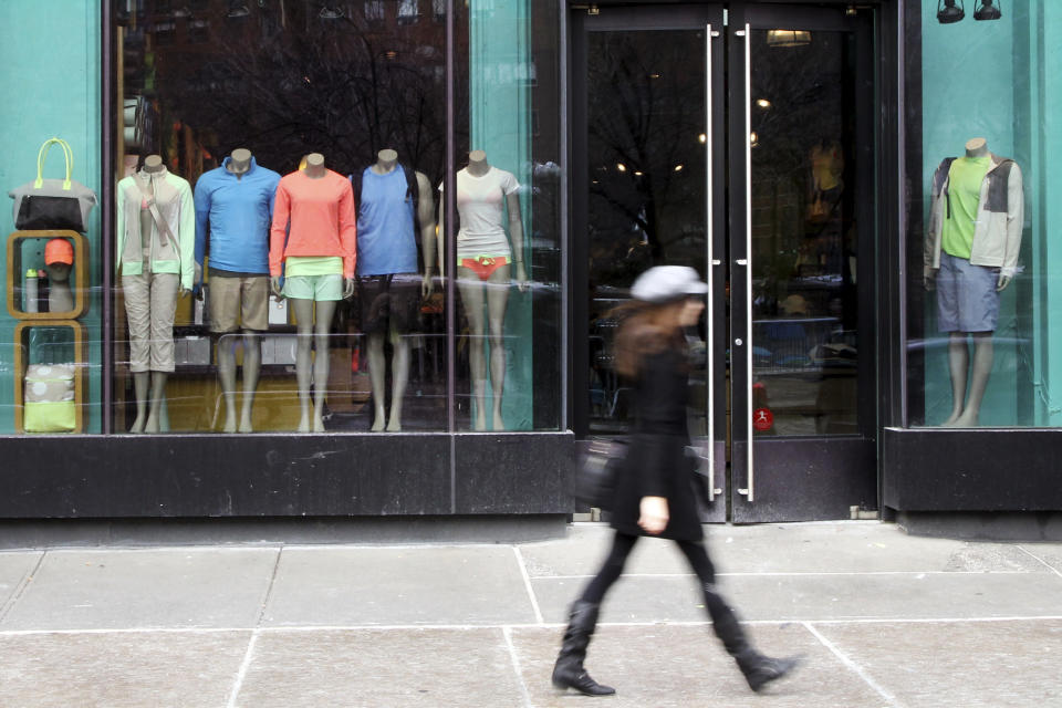 A pedestrian walks past the Lululemon Athletica store Tuesday, March 19, 2013 at Union Square in New York. Lululemon has yanked its popular black yoga pants from store shelves after it found that the sheer material used was revealing too much of its loyal customers. (AP Photo/Mary Altaffer)