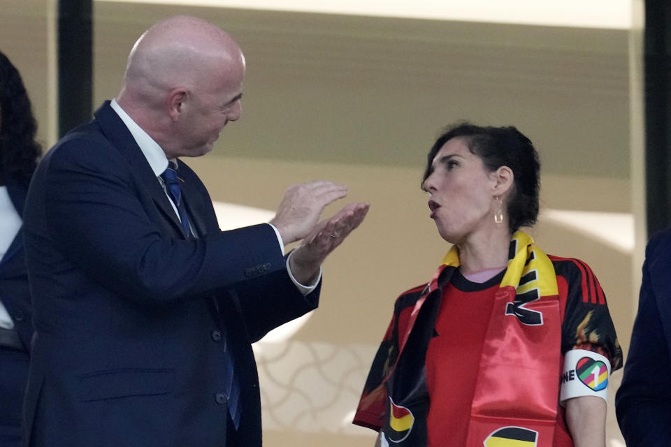 Belgium Foreign Minister Hadja Lahbib, wearing a "One Love" armband, talks with FIFA President Gianni Infantino, left, on the tribune during the World Cup group F soccer match between Belgium and Canada, at the Ahmad Bin Ali Stadium in Doha, Qatar, Wednesday, Nov. 23, 2022. (AP Photo/Natacha Pisarenko)