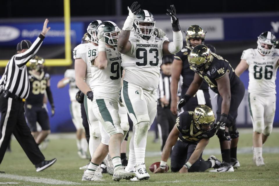 Michigan State defensive tackle Naquan Jones (93) and Jacub Panasiuk (96) celebrate after Wake Forest quarterback Jamie Newman (12) was sacked during the second half of the Pinstripe Bowl NCAA football game Friday, Dec. 27, 2019, in New York. (AP Photo/Frank Franklin II)