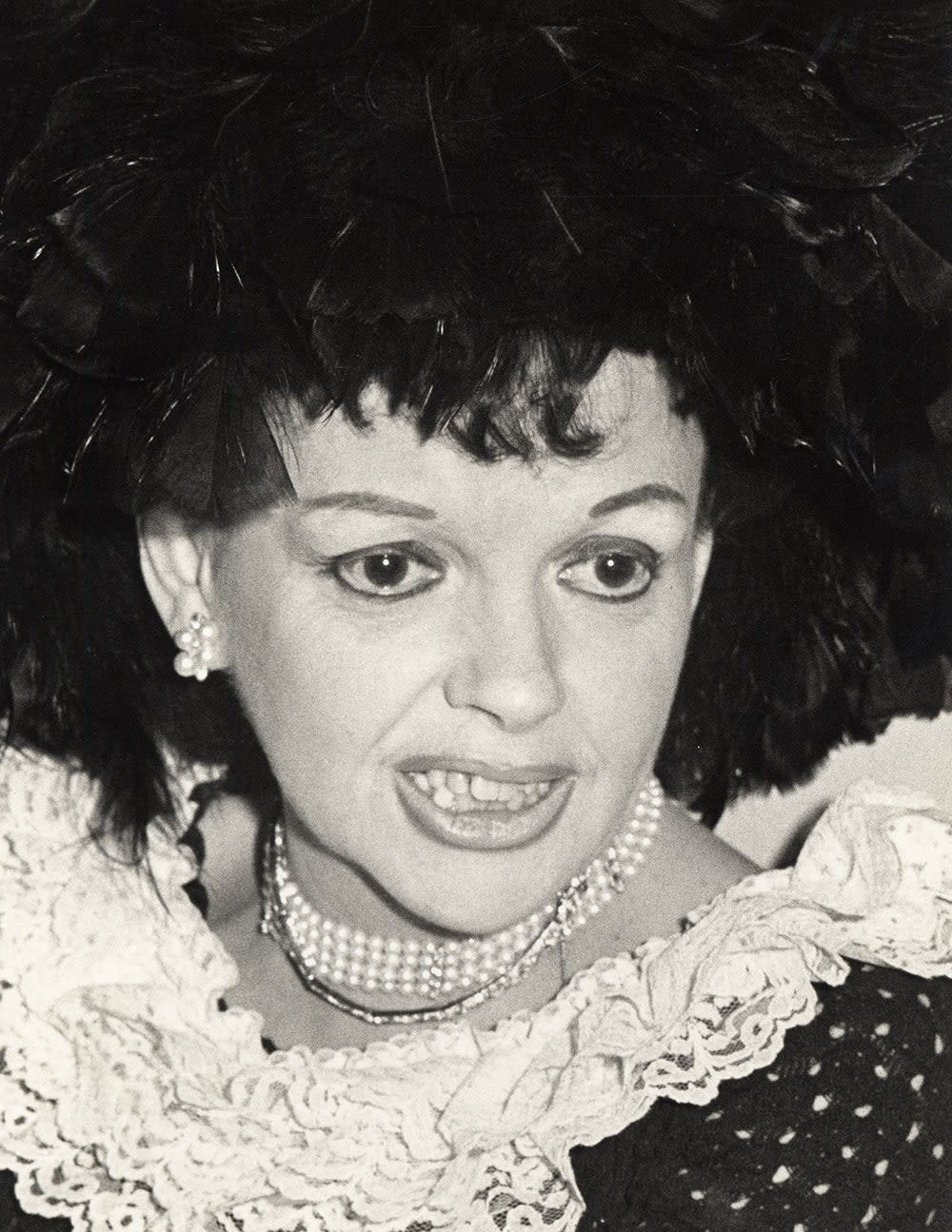 A close-up of Judy Garland wearing a ruffled dress