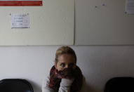 Bosnian woman Denisa Hegic reacts as she enters at the Sejkovaca identification center, near the Bosnian town of Sanski Most, 260 kilometers (162 miles) northwest of Sarajevo ,on Wednesday, April 16, 2014. Denisa Hegic was eight when Serb soldiers stormed her house and killed her entire family at the beginning of the 1992-95 Bosnian war. An aunt pulled her away from her mother's bloody body and they tried to run away, were caught but escaped again. After 22 years, Hegic reunited with her family on Wednesday at the freezing mortuary where the remains of hundreds of Muslim Bosniaks killed during the Bosnain Serb ethnic killings campaign are stored after they were excavated from Bosnia's biggest mass grave.(AP Photo/Amel Emric)