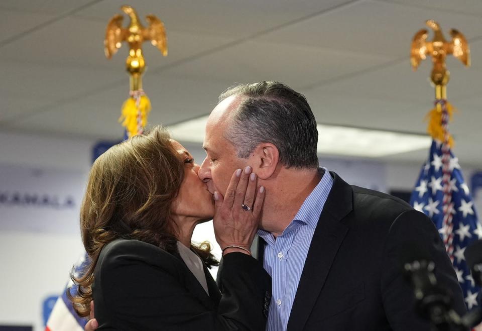Harris and Emhoff kiss before Harris speaks at her campaign headquarters in Delaware on July 22.  Emhoff later said that the vice president told him ‘I need you’ after learning that Joe Biden dropped out of the race. (POOL/AFP via Getty Images)