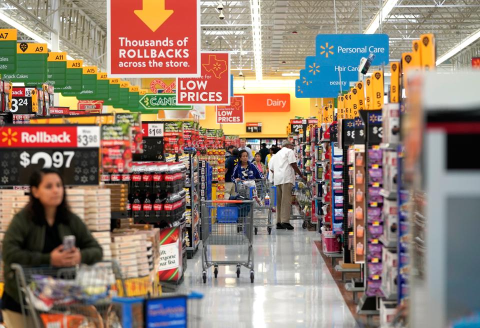 In this Nov. 9, 2018, photo shoppers walk through the isles at a Walmart Supercenter in Houston. Executives at Walmart and dollar-store chains, which import much of their merchandise and serve many low-income customers, have warned that tariffs could lead to higher prices for consumers.