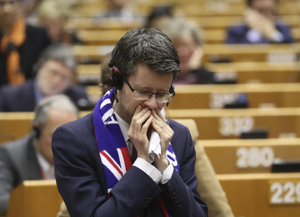 MEP's wear banners and react after a vote on the UK's withdrawal from the EU, the final legislative step in the Brexit proceedings, during the plenary session at the European Parliament in Brussels, Wednesday, Jan. 29, 2020. The U.K. is due to leave the EU on Friday, Jan. 31, 2020, the first nation in the bloc to do so. (Yves Herman, Pool Photo via AP)