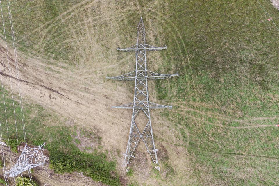 The project has seen 22 pylons laid down and replaced by 60 miles of cables buried 3ft underground. (BNPS)