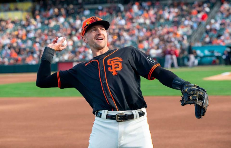 Nick Ahmed of the San Francisco Giants throws a ball up to the stands to a sold-out crowd at Sutter Health Park during an exhibition game with the Sacramento River Cats on Sunday.