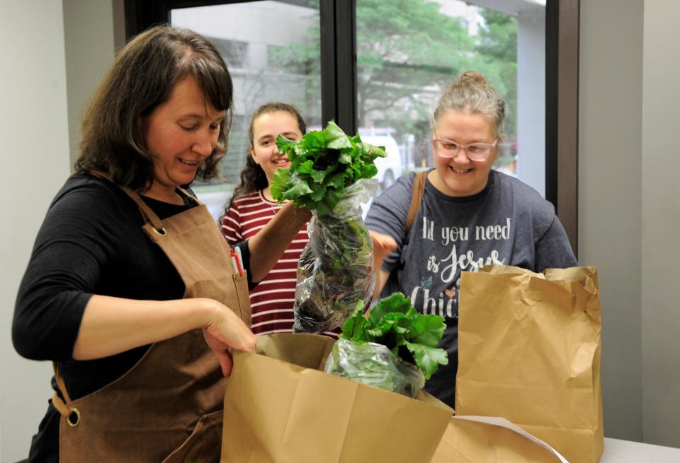 Caroline Koenig, Director of Local Source Food Hub, helps Tammy Ortiz Aleman check her order at the Local Source Food Hub on Thursday, May 19, 2022.