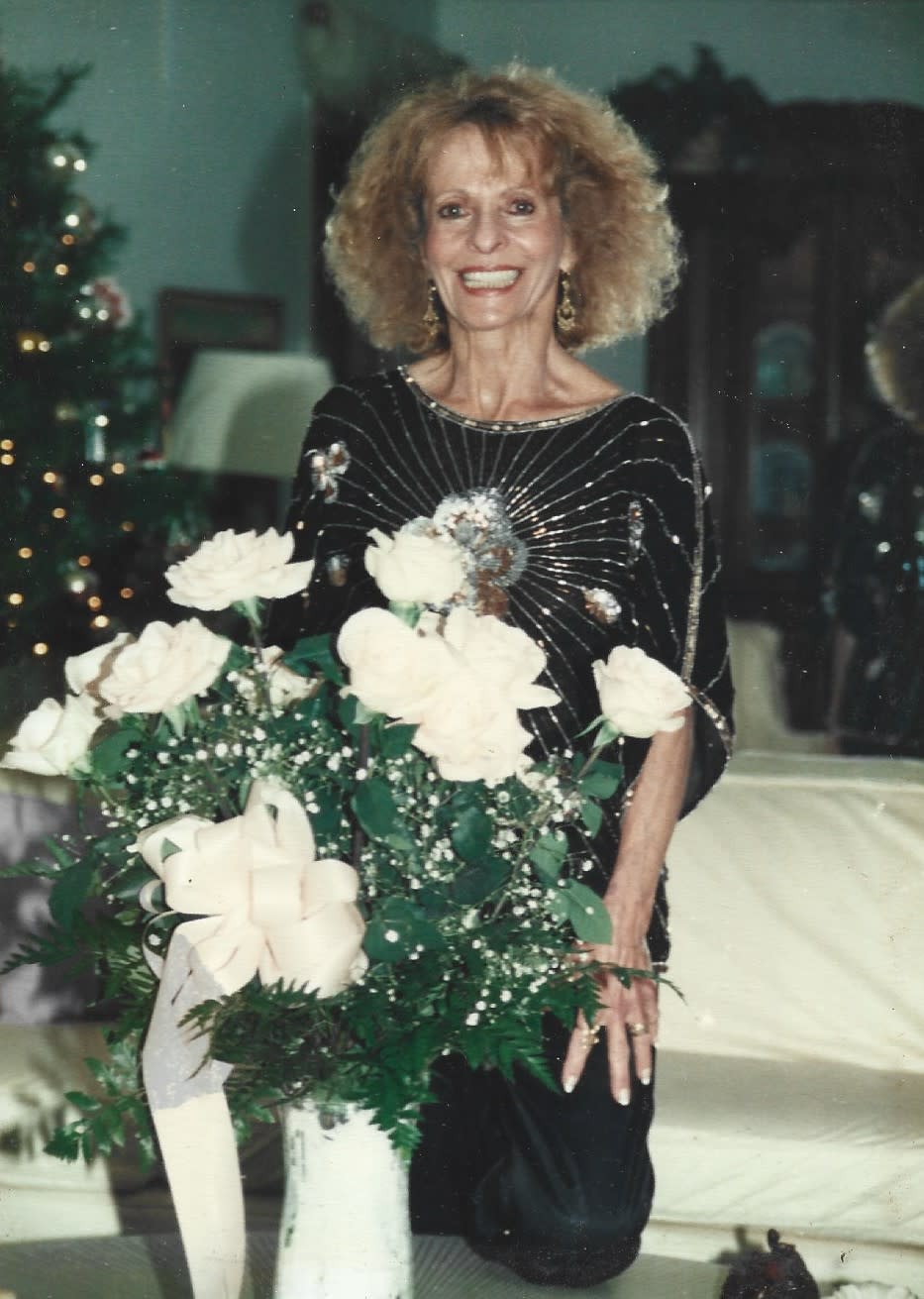 Margie's mother on her 75th Birthday with flowers that Margie sent her