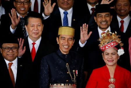 FILE PHOTO: Indonesia president Joko Widodo (C) with his wife Iriana (R) with parliament members pose for pictures after delivering a speech in front of parliament members ahead of independence day in Jakarta, Indonesia, August 16, 2017. REUTERS/Beawiharta/File Photo