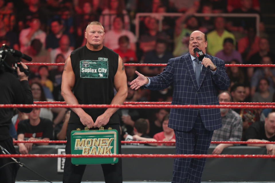 Paul Heyman addresses the crowd as Brock Lesnar holds the "Money in the Bank" briefcase. (Photo courtesy of WWE)