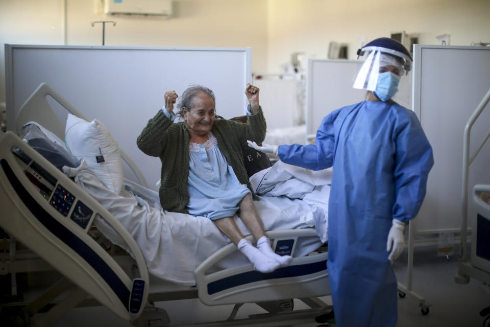 Blanca Ortiz, 84, celebrates after learning that she will be dismissed from the Eurnekian Ezeiza Hospital, on the outskirts of Buenos Aires, Argentina, Thursday, Aug. 13, 2020, several weeks after being admitted with COVID-19. Photographer Natacha Pisarenko said the moment was one of the few she witnessed in months of covering COVID-19 in which doctors and nurses allowed themselves to feel joy. “The moment made all of us in the room with her laugh and feel hopeful again,” Pisarenko said. “It was the brightest moment for me while covering such a heavy story.” (AP Photo/Natacha Pisarenko)