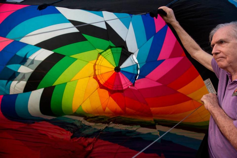 A crew member helps get a hot air balloon up during the Gulf Coast Hot Air Balloon Festival at OWA in Foley, Alabama on Thursday, May 4, 2023.