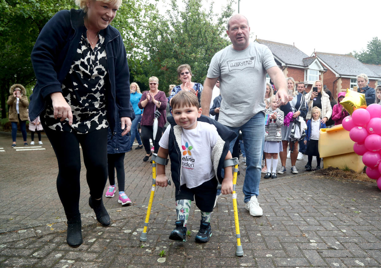 Tony Hudgell, who uses prosthetic legs, takes the final steps in his fundraising walk in West Malling Kent, with mum, Paula and dad Mark. Five-year-old Tony has raised more than �1,000,000 for the Evelina London Children's Hospital, who have cared for him since he was four-months-old, by walking every day in June, covering a distance of 10 kilometres.