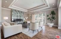 <p>The home has an elegant and modern family room with wood floors and high ceilings. There’s also a home theatre with seating for seven if you want to watch Peters’ upcoming Netflix special on the big screen. <br>(Realtor.com) </p>
