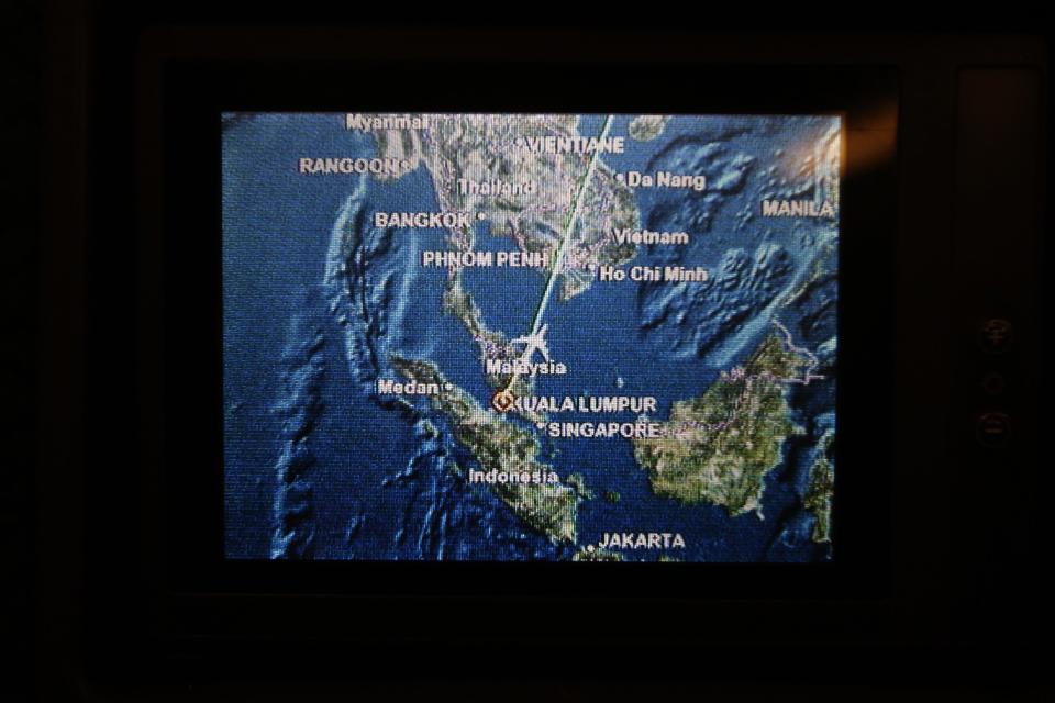 A screen on board Malaysia Airlines Boeing 777-200ER flight MH318 shows the plane's flight path as it cruises over the South China Sea