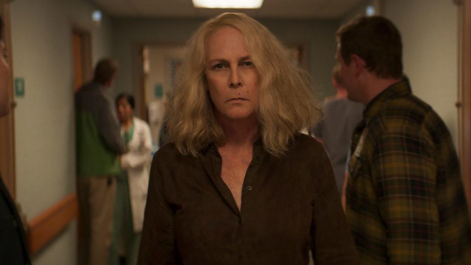 A still from Halloween Kills shows Jamie Lee Curtis as Laurie Strode striding through a hospital