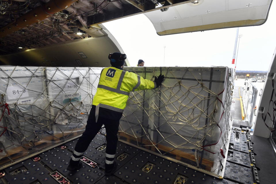 A box containing vaccines is unloaded from a Hungarian Airbus 330 cargo plane as the first batch of the vaccine against the new coronavirus produced by Sinopharm of China arrives at Budapest Liszt Ferenc International Airport in Budapest, Hungary, Tuesday, Feb. 16, 2021. The vaccine will not be used without its examination and approval by the National Public Health Center of Hungary. (Zoltan Mathe/MTI via AP)