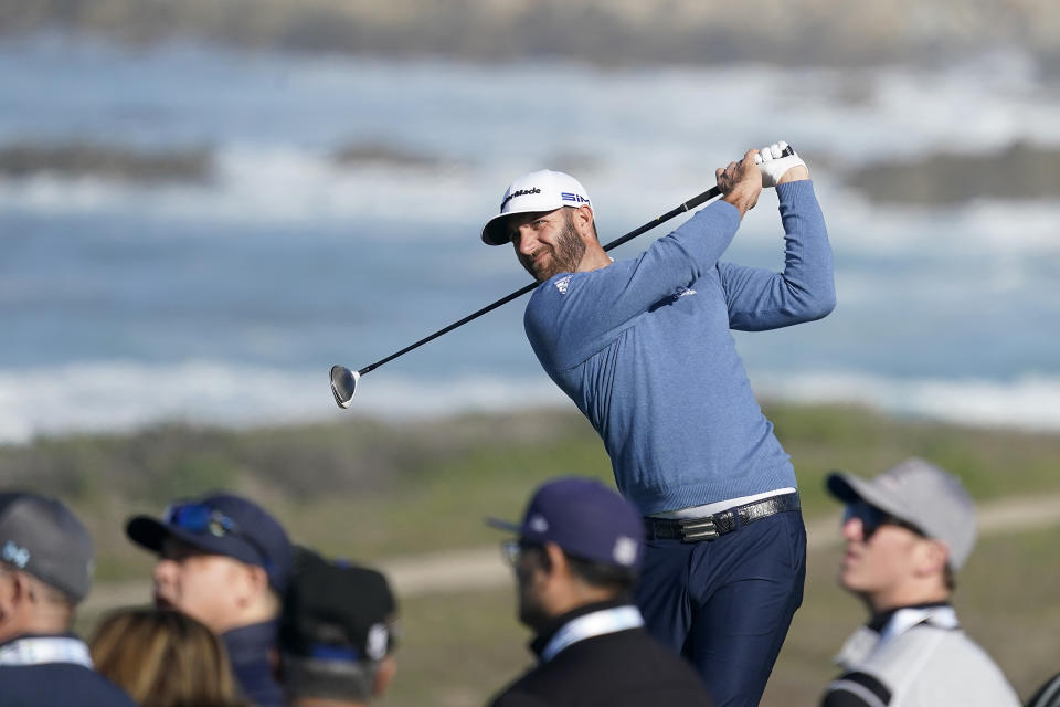 Dustin Johnson hits from the seventh tee of the Monterey Peninsula County Club Shore Course during the second round of the AT&T Pebble Beach National Pro-Am golf tournament Friday, Feb. 7, 2020, in Pebble Beach, Calif. (AP Photo/Tony Avelar)