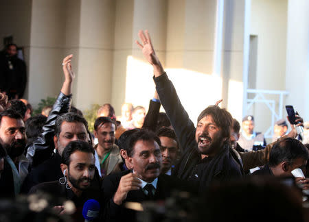 Supporters of Pakistan Tehreek-e-Insaf (PTI) political party, chant slogans after Pakistan's Supreme Court dismissed a petition to disqualify cricket hero and opposition leader Imran Khan from parliament for not declaring assets, in Islamabad, Pakistan December 15, 2017. REUTERS/Faisal Mahmood