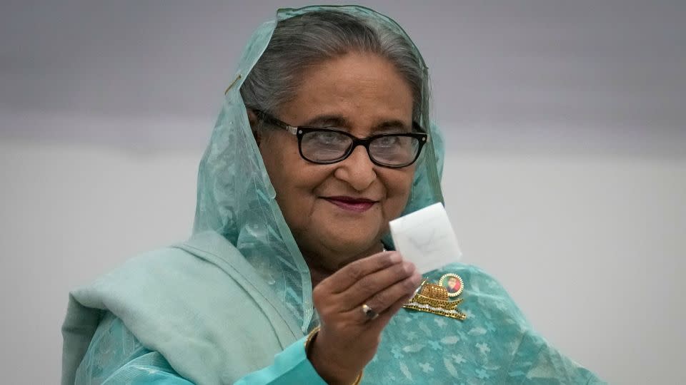 Bangladesh Prime Minister Sheikh Hasina shows her ballot paper as she casts her vote in Dhaka, Bangladesh. - Altaf Qadri/AP