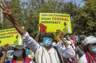 Anti-coup protesters flash the three-fingered salute during a street march in Mandalay, Myanmar, Thursday, Feb. 25, 2021. Protesters against the military's seizure of power in Myanmar were back on the streets of cities and towns on Thursday as regional diplomatic efforts to resolve Myanmar's political crisis intensified Wednesday. (AP Photo)