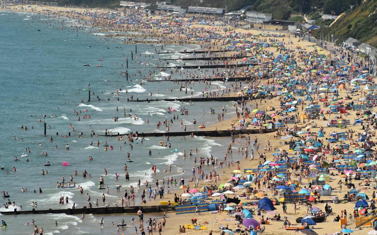 Thousands descended on to Bournemouth beach -  AFP