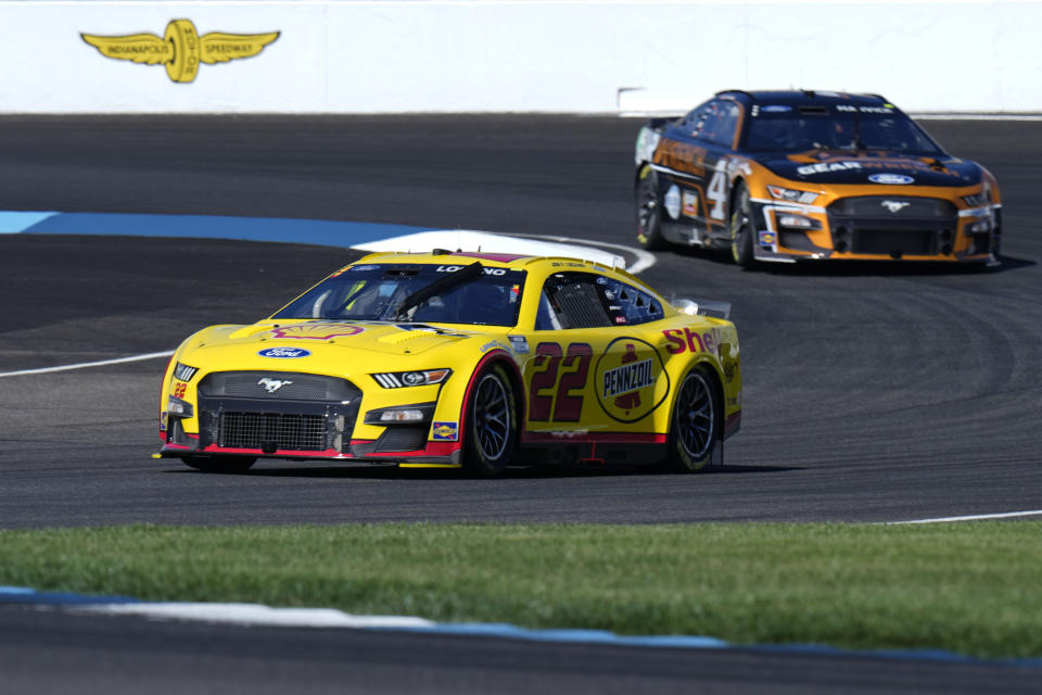 Joey Logano (22) leads Kevin Harvick (4) through the first turn during practice for the NASCAR auto race at Indianapolis Motor Speedway, Saturday, July 30, 2022, in Indianapolis. (AP Photo/AJ Mast)