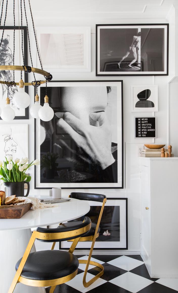 A black, white, and brass kitchen in a rental by Brady Tolbert, spiffed up large scale art.