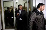 The prosecutor Emiliano Arias (C) with police officers are seen during the confiscation of the documents inside the office of the Ecclesiastical Court of the archdiocese of Santiago, Chile June 13, 2018. REUTERS/Marcelo Hernandez