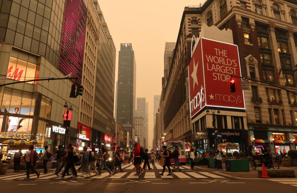 Heavy smoke fills the air as people cross 34th Street in Herald Square in New York City on June 6, 2023.<span class="copyright">Gary Hershorn—Getty Images</span>