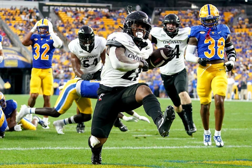 Cincinnati Bearcats running back Corey Kiner (21) runs for a touchdown in the second quarter of a college football game between the Cincinnati Bearcats at the Pittsburgh Panthers, Saturday, Sept. 9, 2023, at Acrisure Stadium in Pittsburgh, Pa.