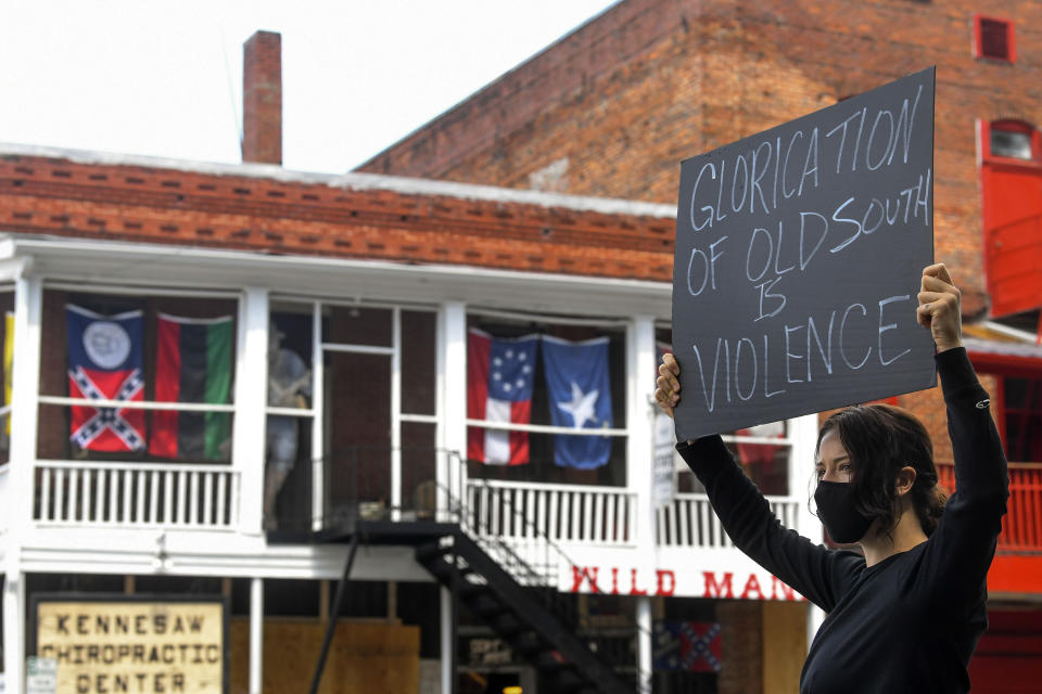 Chelsea Shag holds up a sign as demonstrators protest June 5 across the street from a Confederate memorabilia store in Kennesaw, Georgia. (Photo: John Amis/Atlanta Journal-Constitution via Associated Press)