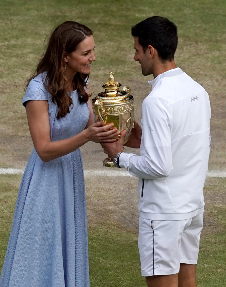 The Duchess of Cambridge hands the winner's trophy to Serbia's Novak Djokovic after beating Switzerland's Roger Federer during their men's singles final on day thirteen of the 2019 Wimbledon Championships at The All England Lawn Tennis Club in Wimbledon