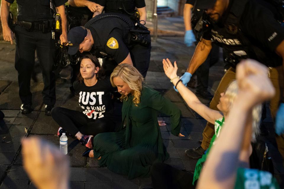Sen. Lauren Book, seated right, along with Democratic Chairwoman Nikki Fried, seated left, and about a dozen activists who were protesting Florida's six-week abortion ban, are arrested outside the Tallahassee City Hall building, Monday, April 3, 2023, in Tallahassee, Florida.
