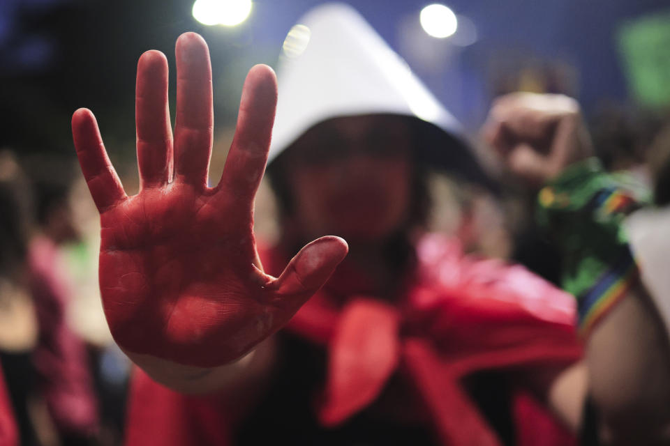 An abortion rights activist her hand painted blood red takes part in a march against an anti-abortion congressional bill, along Paulista Avenue in Sao Paulo, Saturday, June 15, 2024. (AP Photo/Ettore Chiereguini)