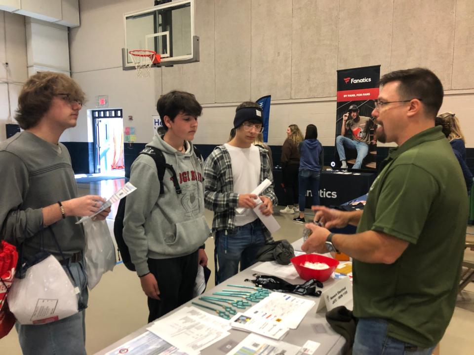 Daryl Jones of Marietta talks with Licking Valley students Brayden Reed, Evan Harris and Jack Macri about opportunities with the Newark Electrical Joint Apprenticeship Training Committee (JATC), during last week's job fair at the high school.