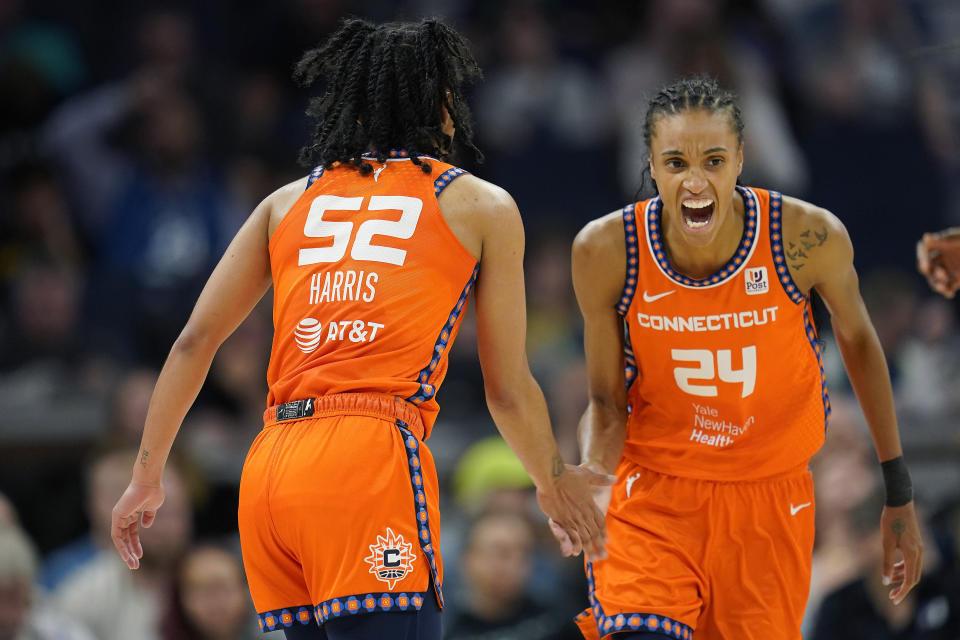 Connecticut Sun forward DeWanna Bonner (24) celebrates toward guard Tyasha Harris after Harris made a 3-pointer during Game 3 of a 2023 WNBA first-round playoff series against the Minnesota Lynx on Sept. 20, 2023, in Minneapolis. (AP Photo/Abbie Parr)