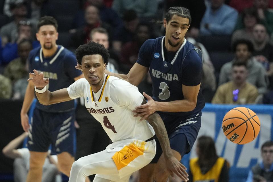 Arizona State's Desmond Cambridge Jr. (4) and Nevada's Trey Pettigrew (3) go for a loose ball during the first half of a First Four college basketball game in the NCAA men's basketball tournament, Wednesday, March 15, 2023, in Dayton, Ohio. (AP Photo/Darron Cummings)