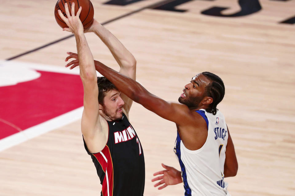 Miami Heat guard Goran Dragic (7) holds the ball as Indiana Pacers forward T.J. Warren (1) defends during the first half of Game 3 of an NBA basketball first-round playoff series, Saturday, Aug. 22, 2020, in Lake Buena Vista, Fla. (Kim Klement/Pool Photo via AP)