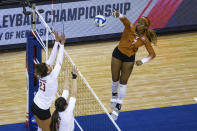 Texas' Asjia O'Neal (7) scores a point against Wisconsin's Molly Haggerty (23) and Danielle Hart (18) in the first set during a semifinal in the NCAA women's volleyball championships Thursday, April 22, 2021, in Omaha, Neb. (AP Photo/John Peterson)