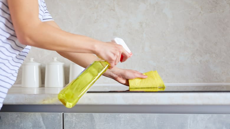 Person cleaning cooktop