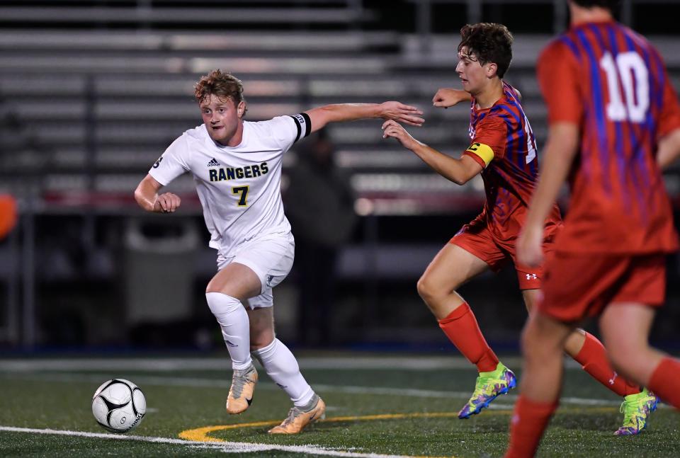 Spencerport's Kyle Milburn, left, dribbles away from Fairport's Tyler Burton during a regular season game, Thursday, Oct. 12, 2023.