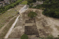 An aerial view of freshly dug graves expand across a section of La Bermeja General Cemetery to meet the demands of the increase in deaths related to the new coronavirus, in San Salvador, El Salvador, Friday, Aug. 7, 2020. For months, the strictest measures confronting the COVID-19 pandemic in Latin America seemed to keep infections in check in El Salvador, but a gradual reopening combined with a political stalemate has seen infections increase nearly fourfold. (AP Photo/Salvador Melendez)