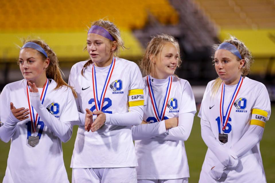 Olentangy soccer players, from left, Kylee Beinecke, Rachel Austin, Helena Ronnebaum and Carly Ross receive their runner-up medals following their loss to Strongsville in the state championship on Nov. 13, 2020.