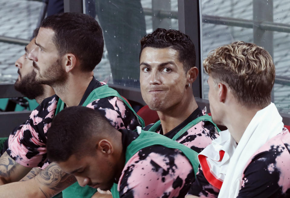 Cristiano Ronaldo, second from right, of Juventus sits on the bench prior to a friendly match against Team K League at the Seoul World Cup Stadium in Seoul, South Korea, Friday, July 26, 2019. (AP Photo/Ahn Young-joon)