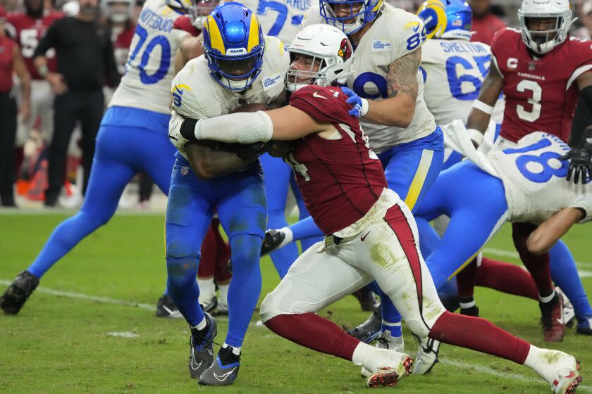 Arizona Cardinals defensive end Zach Allen (94) tackles Los Angeles Rams running back Cam Akers.