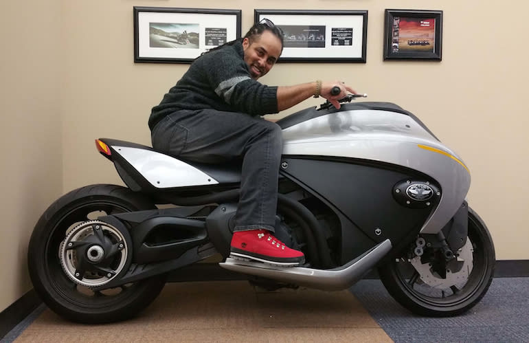 Designer Tiger Bracy sits on the Vision 800 concept, which is now displayed in his office.