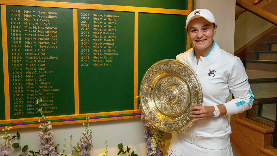 Ash Barty, pictured here in front of the Ladies' Singles Winner's Board after winning Wimbledon.