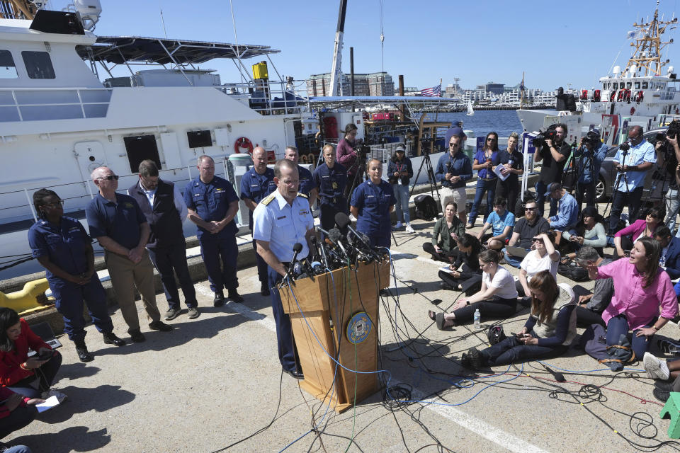 U.S. Coast Guard Rear Adm. John Mauger, commander of the First Coast Guard District, center at microphone, talks to the media Thursday, June 22, 2023, at Coast Guard Base Boston, in Boston. The U.S. Coast Guard says the missing submersible imploded near the wreckage of the Titanic, killing all five people on board. Coast Guard officials said during a news conference that they've notified the families of the crew of the Titan, which has been missing for several days. (AP Photo/Steven Senne)