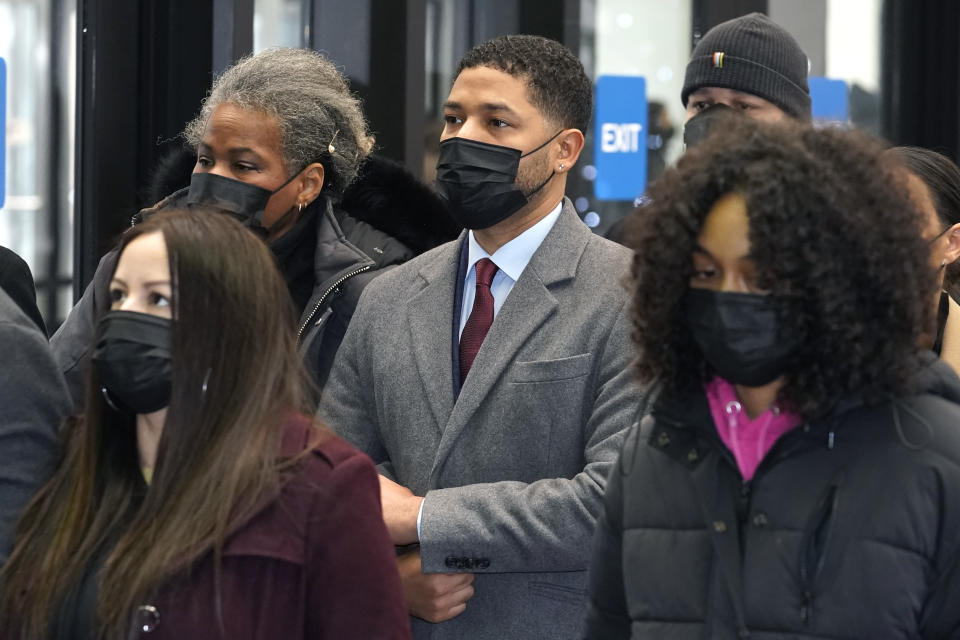 Actor Jussie Smollett, center, arrives with his mother Janet, left, and other family members at the Leighton Criminal Courthouse for day three of his trial in Chicago on Wednesday, Dec. 1, 2021. Smollett is accused of lying to police when he reported he was the victim of a racist, anti-gay attack in downtown Chicago nearly three years ago. (AP Photo/Charles Rex Arbogast)